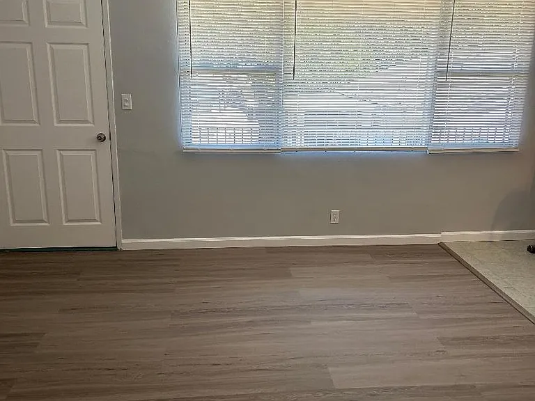 front Living room with brand new mini blinds, brand new linemate floor
