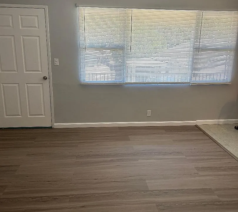 front Living room with brand new mini blinds, brand new linemate floor