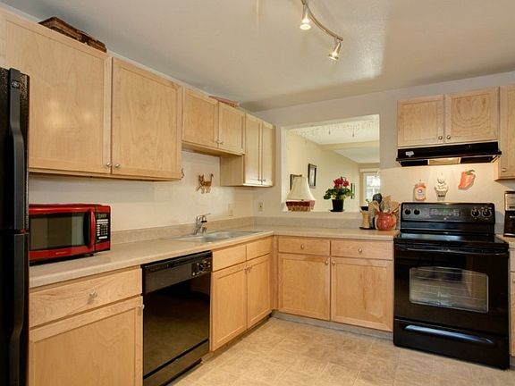 Large kitchen with plenty of counter & cabinet space. Pass through to dining area. All appliances stay!