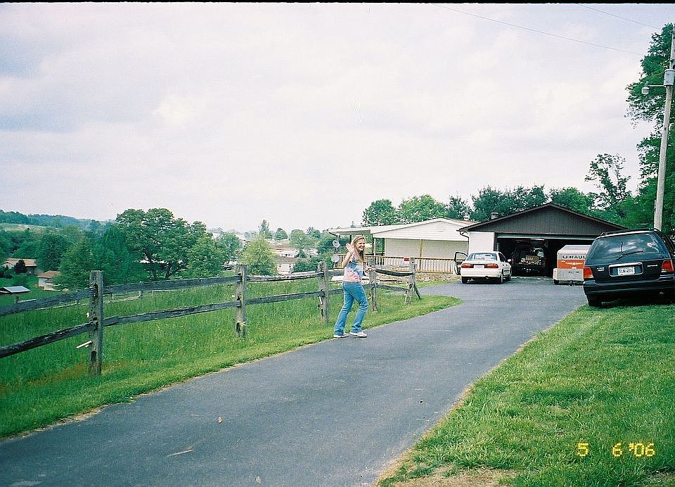 View of property, home, and garage