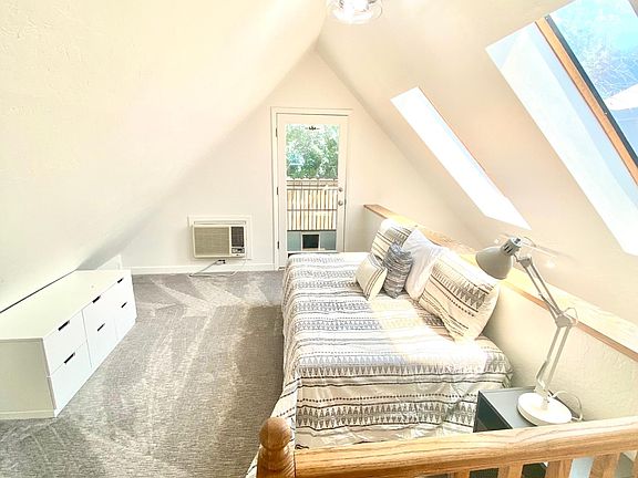 upstairs loft with deck access and daybed bed, dresser