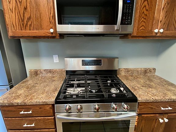 New never used gas stove with built in griddle for hot pancakes and new microwave oven.