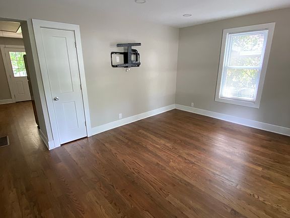 Living room with TV mount and outlet on wall.
