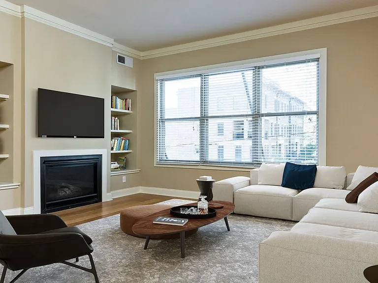 Living room with wood flooring and patio access