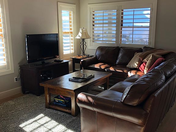 Living room, lots of natural light comes through.