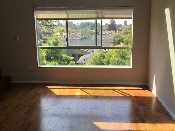 Louise Apartments unfurnished living area with large window
