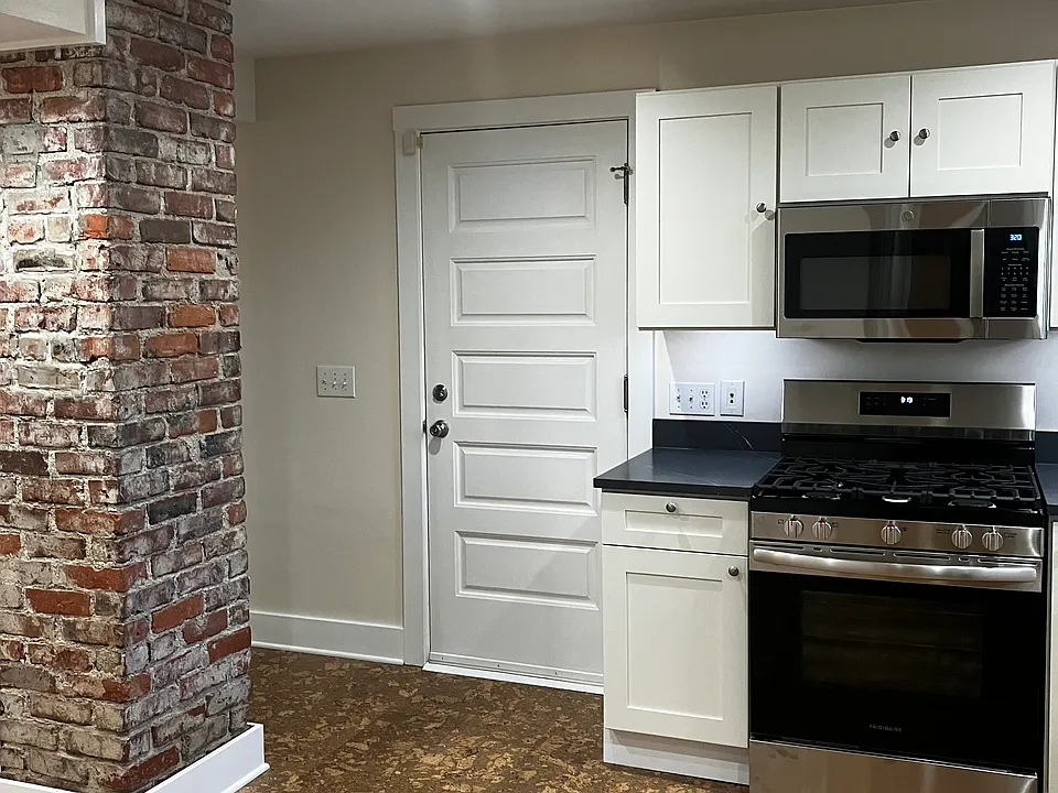 entry door pictured. note interesting architectural features like exposed brick