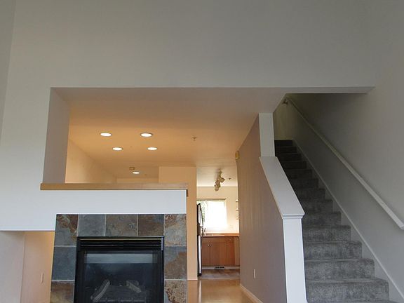 Your main living room with high ceilings, gas fireplace, and views of the East Seattle mountains.