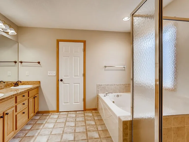 Primary bedroom bathroom. Includes jetted tub and separate shower.