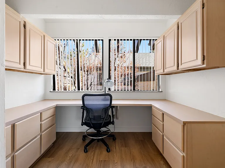 The main bedroom includes a spacious private workspace with a large desk and cabinets
