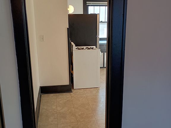 Just inside the entrance facing W towards kitchen