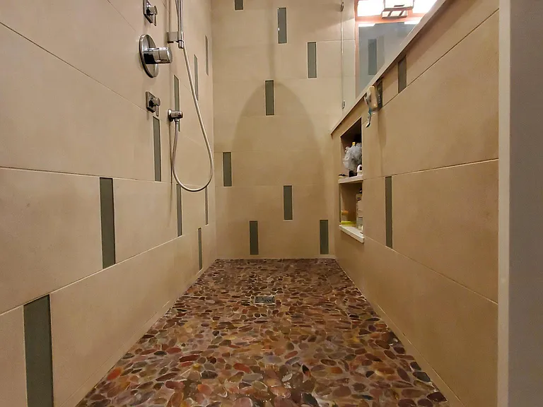 Primary bathroom has heated tile floors throughout, walk-in shower with rain head and personal shower, double vanity and a whirlpool soaking tub.
