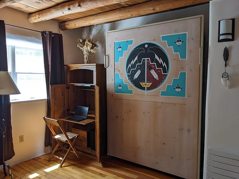 Workstation and murphy bed with original Native American painting in guest bedroom