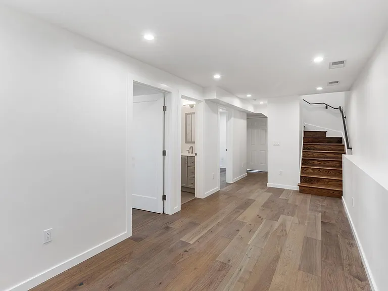 Lower level landing with large lounge room, two extra bedrooms and a bathroom