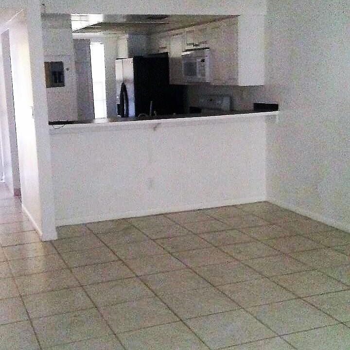 Modern kitchen with counter/bar open to DR/LR