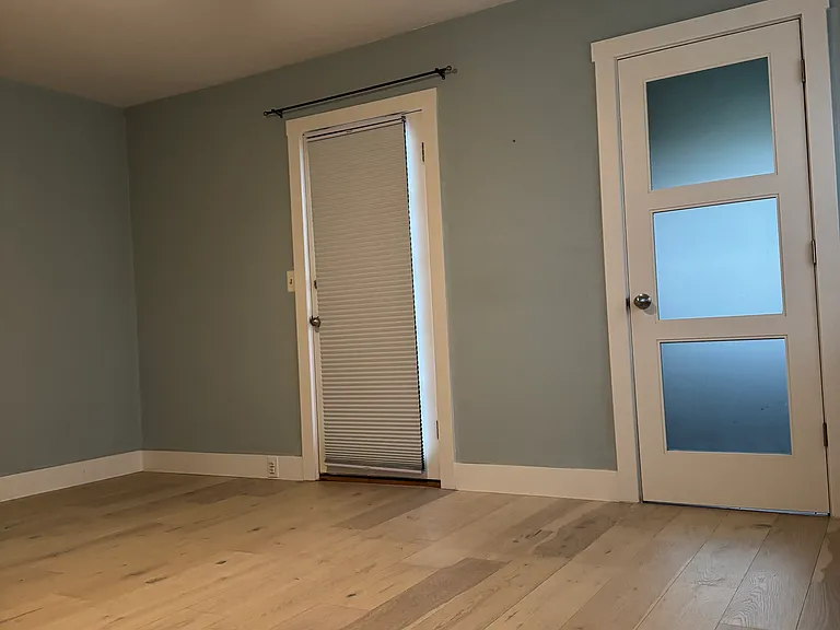 Large Master Bedroom ~ left door leads to outdoor patio, right door leads to en suite bathroom. Opposite wall large enough for king size bed and two bedside tables.