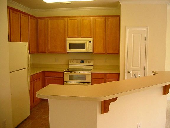 Open kitchen 42" cabinets w/crownon top, flat top stove and built in micro.