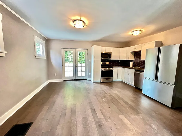 open concept kitchen with stainless steel appliances. French doors leading to the back patio.