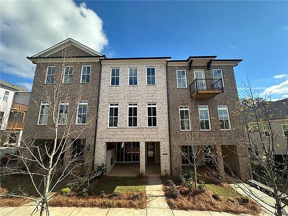 The exterior features a classic brick facade, providing a sturdy and low-maintenance home