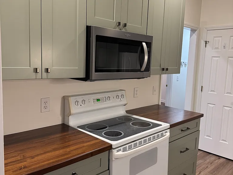 Fully updated kitchen with custom cabinets and designer inspired butcher block countertops.