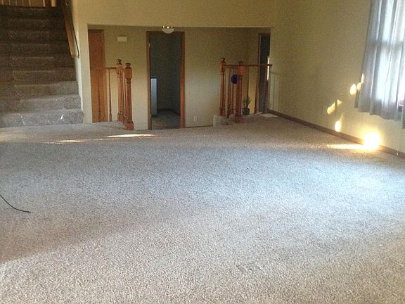 Living room. Stairway to the left up to bedrooms. Stairway on the right down to front door.