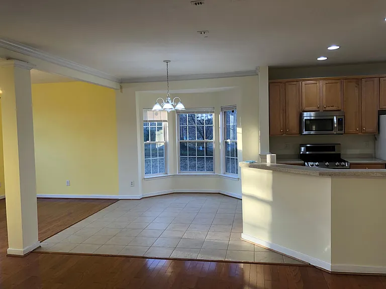 Dinette and kitchen from living room.Gorgeous open floor plan. Stone tile flooring in Dinette and Kitchen.