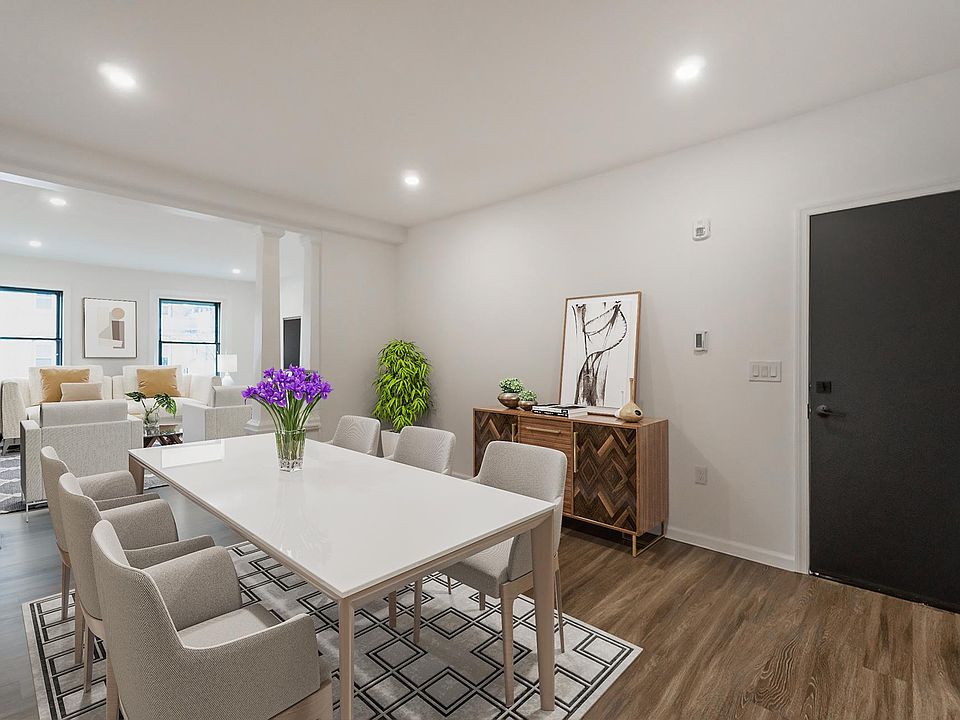 Front door leading into dining with family room in front. Virtually staged.