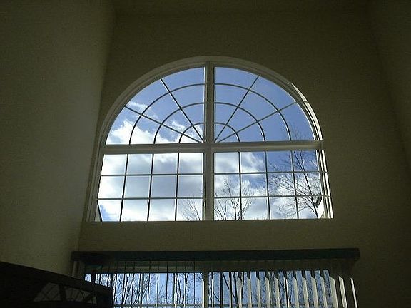 Cathedral Celing with Large Windows and view of forest