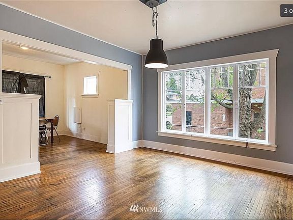 Nice, big window in the dining room. Hardwood floor will be refinished. Walls will be painted. Light fixture will be updated.