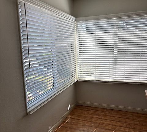 Big windows overlooking the lawn and street in the dining nook- all new window shades