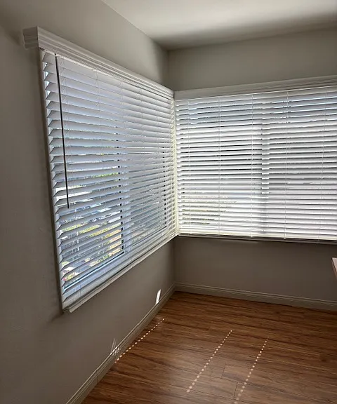 Big windows overlooking the lawn and street in the dining nook- all new window shades