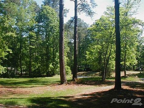 Very pretty, woodsy lot in great location close to lake, boat launch, basketball court and convenien