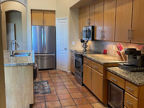 Kitchen with Stanless steel appliances and mini fridge. Extra Freezer in the garage