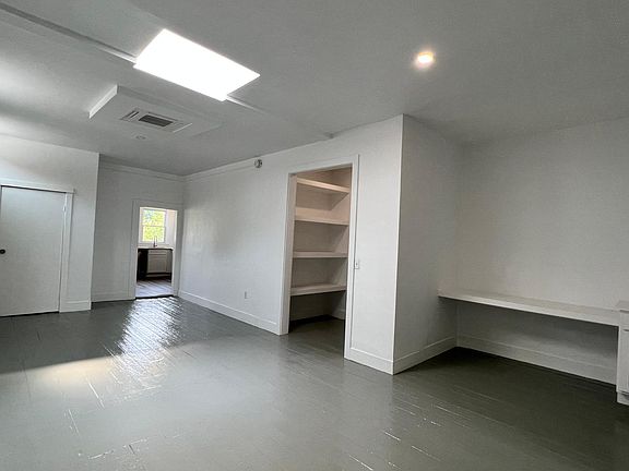 Center - Living Room with Work Area and Huge Storage Closet.