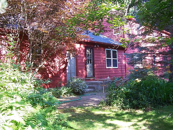 Back view of exterior, with brick patio and walkway