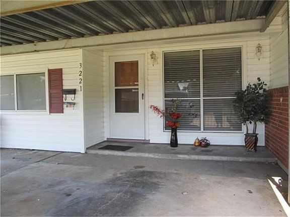 NICE COVERED FRONT PORCH AND DRIVE WAY