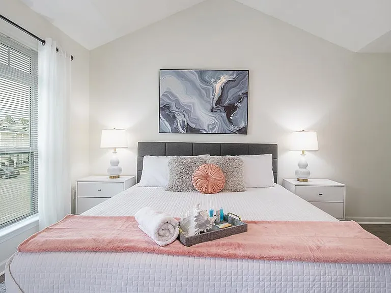 Welcome to your tranquil beach-themed master bedroom, a haven of relaxation where the soothing embrace of the sea meets the comfort of a luxurious retreat.