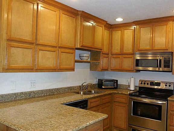 Completely updated kitchen with wood cabinetry, granite counters, stainless appliances and 16 inch s