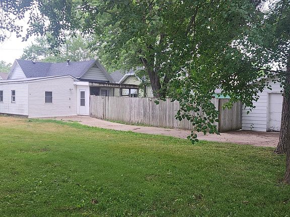 This is an image of the back yard. There is a driveway and a garage in back of the house accessible from the alley.