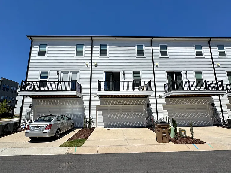 Rear. Garage access with deck off main living area.