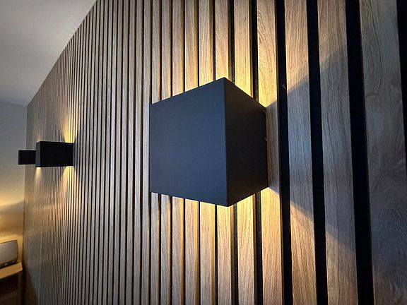 Battery operated sconce ambiance lighting - remote controlled. Acoustic accent wall.