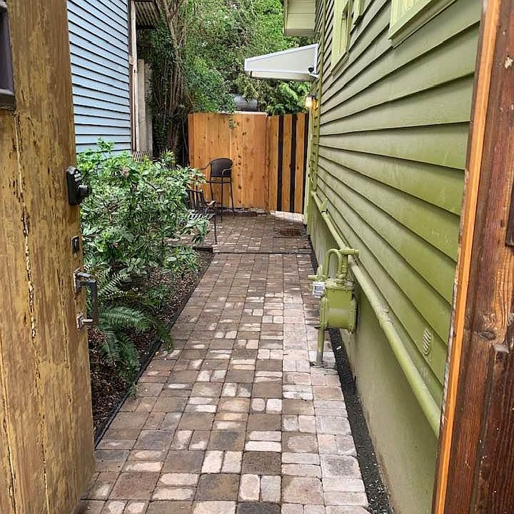 THROUGH GATE, PAVED WALKWAY AND PATIO TO HANG OUT. GARDEN WITH NATIVE PLANTS