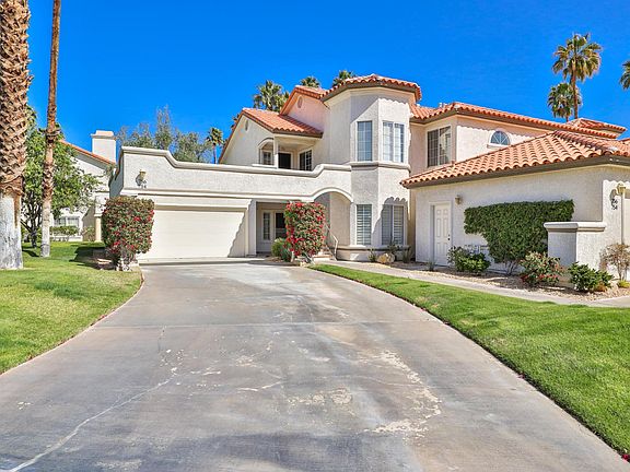 The long driveway leads to our first story corner home, with nice front and side lawns.
