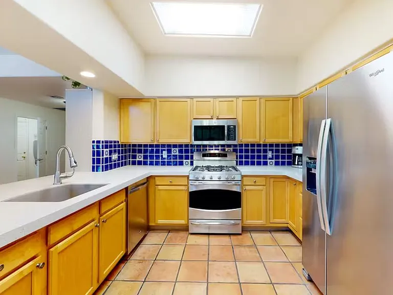 Fully equip kitchen including microwave, oven, freezer, refrigerator, and many small appliances.