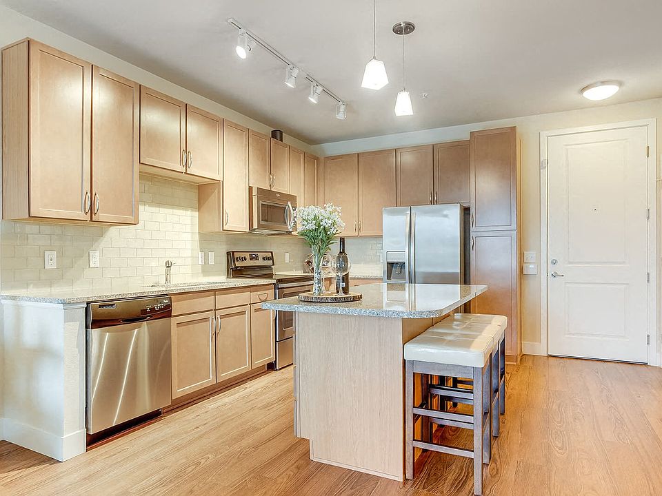 Designer kitchens with stainless steel, granite counters and a tiled backsplash