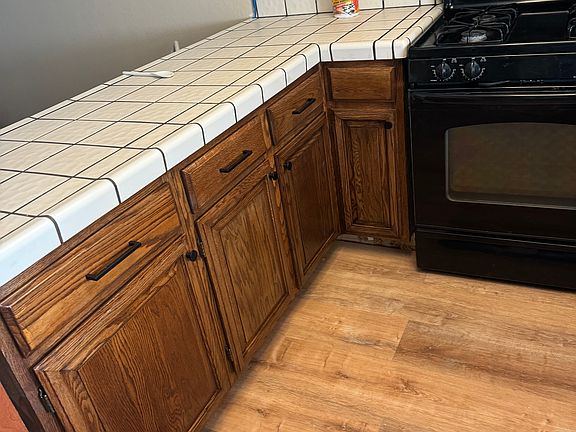Shared kitchen with newly stained cabinets, new dishwasher, and new sink.