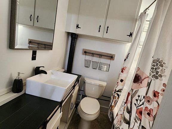 We maximized storage in the bathroom with a lovely new barn door vanity and vintage style sink.. original ball and claw tub.. hold the heat beautifully for tubbies!