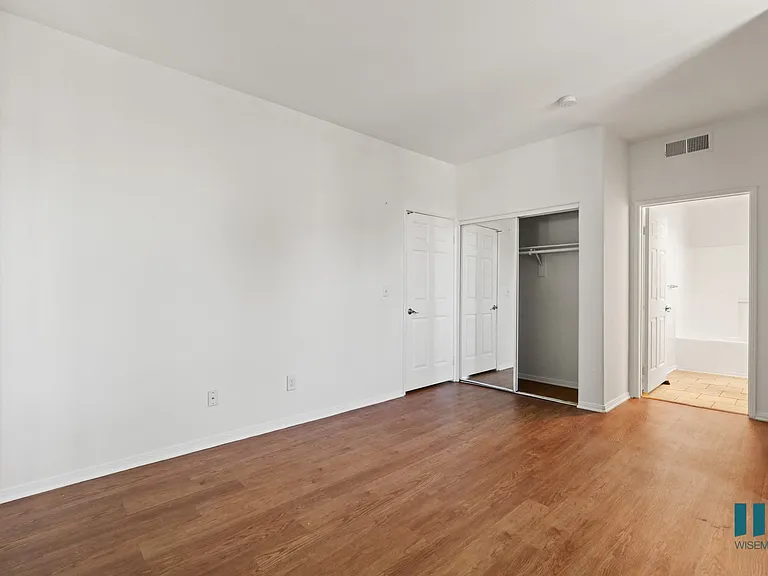 Bedroom with Bathroom, Closet, and Vinyl Flooring