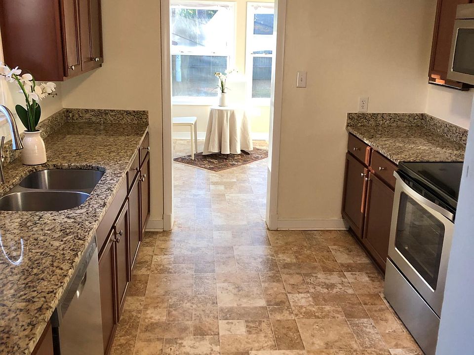 Updated kitchen with granite countertops, stainless steel appliances and solid core cabinets. Easy flow into the dining room or family room.