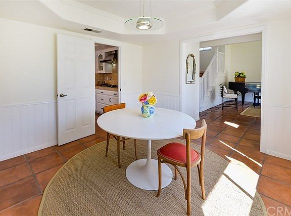 Another view of the dining room showing the kitchen to the left and the formal living room to the right.